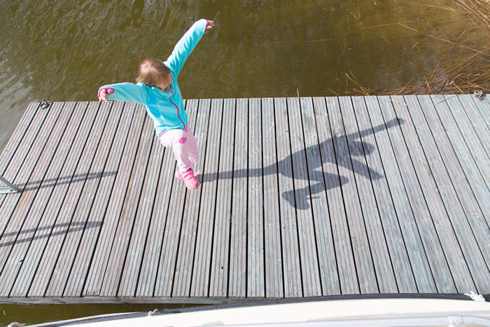 Girl jumping on a pier - Pixbuster Free Images