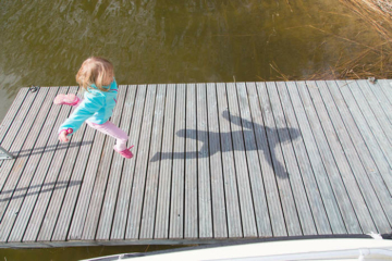 Girl jumping on a pier - Pixbuster Free Images