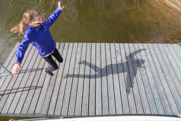 Girl jumping on a pier - Pixbuster Free Images