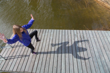 Girl jumping on a pier - Pixbuster Free Images